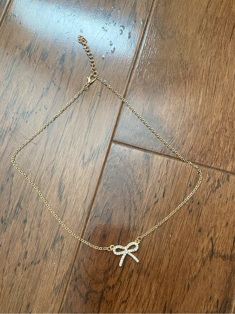 Gold tone bow necklace with rhinestones